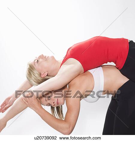 Stock Image - 2 women stretching. Fotosearch