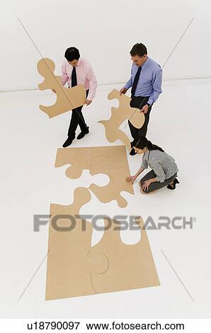 3 business people complete the puzzle View Large Photo Image Stock Photo - 3 business people complete the puzzle. Fotosearch
