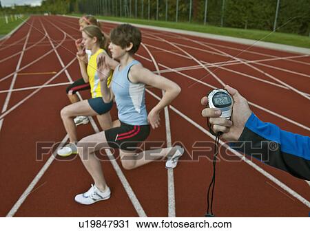 Stock Image - 3 female athletes and trainer . Fotosearch
