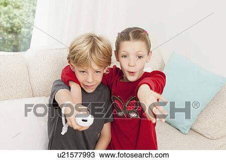 Stock Image - A boy and girl using a games console. Fotosearch