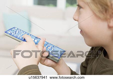 A boy using a remote control View Large Photo Image Stock Image - A boy using a remote control. Fotosearch