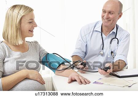 A doctor taking blood pressure View Large Photo Image Stock Photo - A doctor taking blood pressure. Fotosearch
