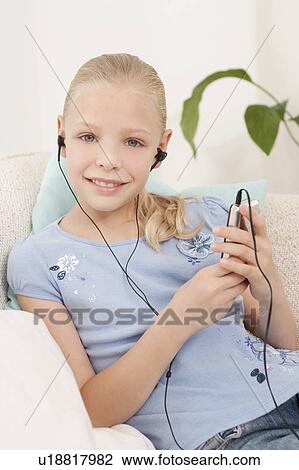 Stock Image - A girl listening to an MP3 player. Fotosearch