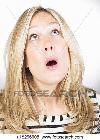 A surprised woman looking up View Large Photo Image Stock Photo - A surprised woman looking up. Fotosearch