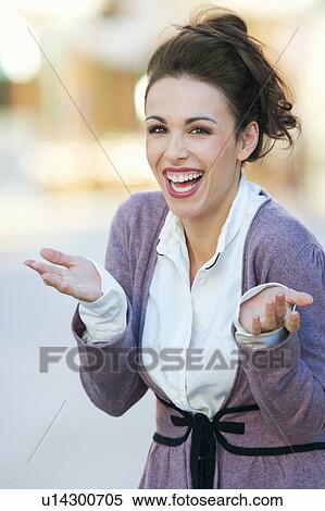 A woman laughing and gesturing to camera View Large Photo Image Stock Photography - A woman laughing and gesturing to camera. Fotosearch