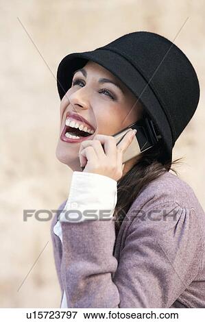 A woman laughing on a mobile phone View Large Photo Image Stock Photo - A woman laughing on a mobile phone. Fotosearch