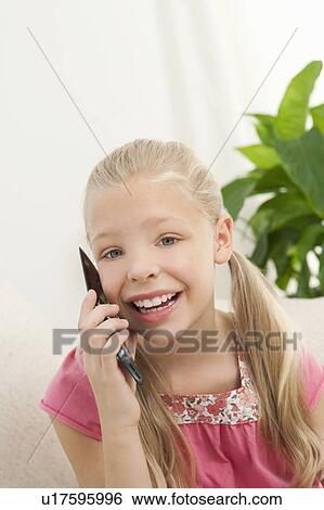 A young girl on a mobile phone View Large Photo Image Stock Photograph - A young girl on a mobile phone. Fotosearch