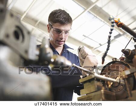 Stock Photography - Apprentice Working With Lathe. Fotosearch