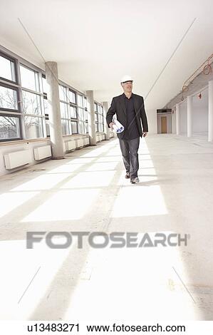Stock Image - Architect checking construction site. Fotosearch