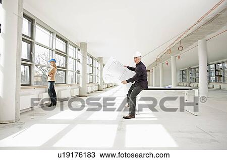 Architects working together on site View Large Photo Image Stock Image - Architects working together on site. Fotosearch