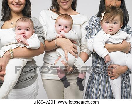 Babies in mothers' arms View Large Photo Image Stock Image - Babies in mothers' arms. Fotosearch