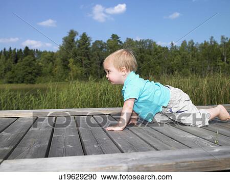 Baby boy on a dock View Large Photo Image Stock Image - Baby boy on a dock. Fotosearch