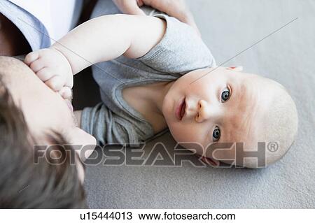 Baby boy with dad looking up to camera View Large Photo Image Stock Image - Baby boy with dad looking up to camera. Fotosearch