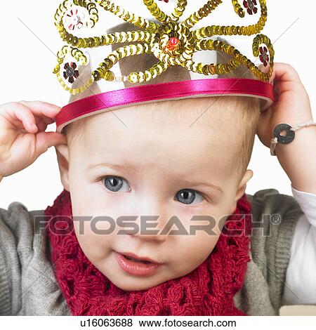 Stock Photo - Baby girl with a crown on her head. Fotosearch