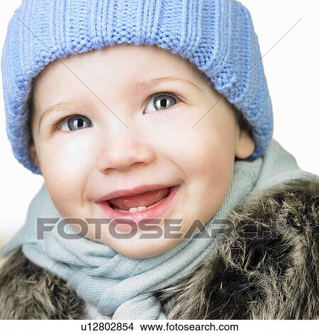 Picture - Baby girl with a hat, smiling. Fotosearch