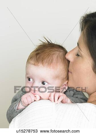Stock Image - Baby on mothers shoulder. Fotosearch
