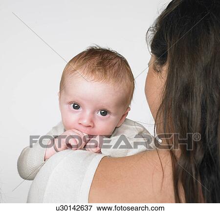 Baby on mothers shoulder View Large Photo Image Stock Photo - Baby on mothers shoulder. Fotosearch