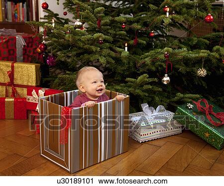 baby playing inside christmas present View Large Photo Image Stock Image - baby playing inside christmas present. Fotosearch