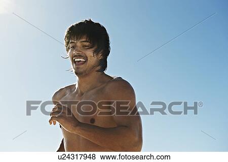 Bare chested man running in sunlight View Large Photo Image Stock Photo - Bare chested man running in sunlight. Fotosearch