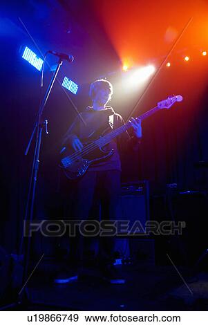 Bass guitarist on stage View Large Photo Image Stock Photo - Bass guitarist on stage. Fotosearch