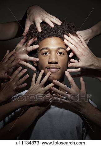 Black male surrounded by hands View Large Photo Image Stock Image - Black male surrounded by hands. Fotosearch