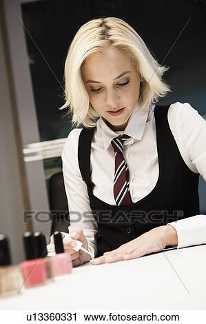 Blond woman polishing nails View Large Photo Image Stock Image - Blond woman polishing nails. Fotosearch