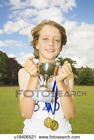 Boy athlete with trophy and medals View Large Photo Image Stock Image - Boy athlete with trophy and medals. Fotosearch
