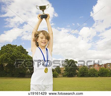 Boy athlete with trophy and medals View Large Photo Image Stock Photo - Boy athlete with trophy and medals. Fotosearch