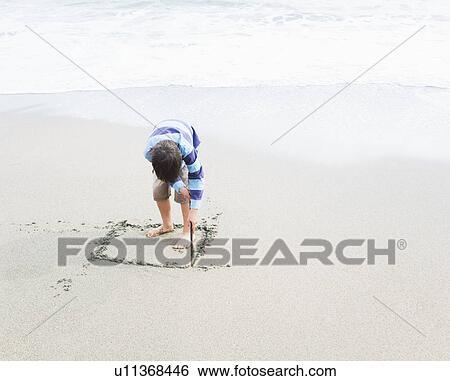 Boy drawing square in sand View Large Photo Image Stock Photograph - Boy drawing square in sand. Fotosearch