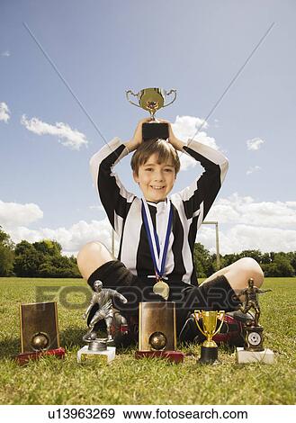 Boy footballer with Trophies and medals View Large Photo Image Stock Photo - Boy footballer with Trophies and medals. Fotosearch