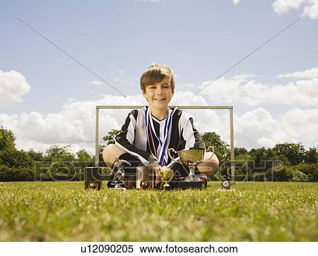 Boy footballer with Trophies View Large Photo Image Stock Photography - Boy footballer with Trophies. Fotosearch