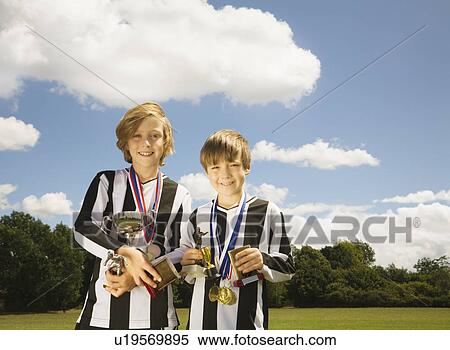Boy footballers with Trophies View Large Photo Image Stock Photography - Boy footballers with Trophies. Fotosearch