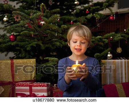 boy holding candle at christmas View Large Photo Image Stock Image - boy holding candle at christmas. Fotosearch