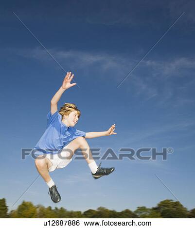 Stock Photograph - Boy Jumping in air. Fotosearch