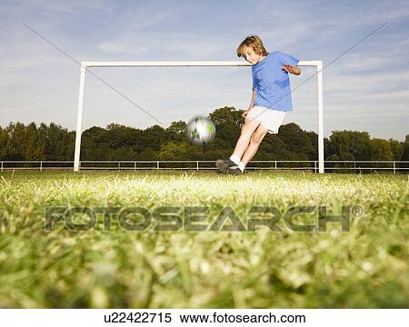 Boy kicking football in front of goal View Large Photo Image Stock Photography - Boy kicking football in front of goal. Fotosearch