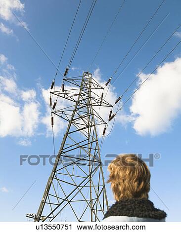 Stock Image - Boy looking at pylon. Fotosearch