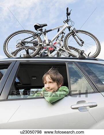 Stock Photo - Boy looking out of car window. Fotosearch