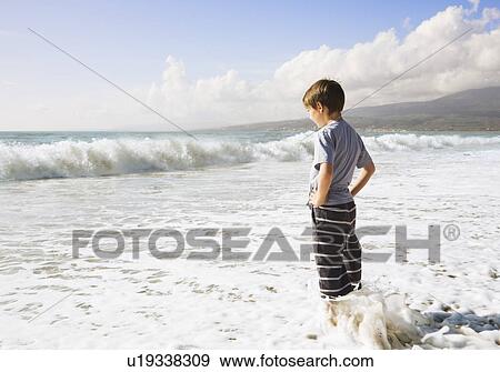 Boy looking out to sea View Large Photo Image Stock Photo - Boy looking out to sea. Fotosearch
