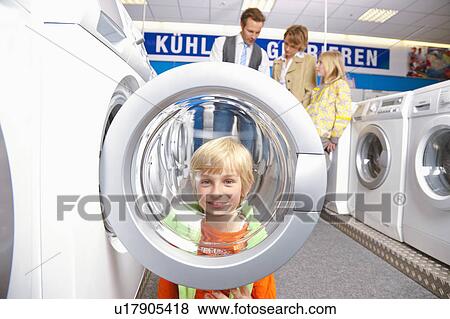 Boy looking through machines' bulls eye View Large Photo Image Stock Photo - Boy looking through machines' bulls eye. Fotosearch