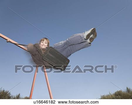 Boy on swing View Large Photo Image Stock Image - Boy on swing. Fotosearch