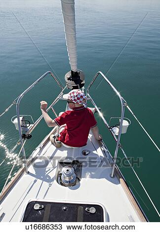 Boy on yacht View Large Photo Image Stock Image - Boy on yacht. Fotosearch