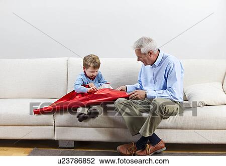 Boy opening present with grandfather View Large Photo Image Stock Image - Boy opening present with grandfather. Fotosearch