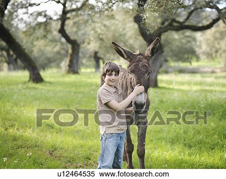 Boy posing with his donkey View Large Photo Image Stock Photography - Boy posing with his donkey. Fotosearch