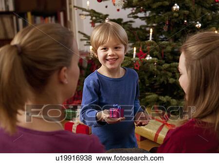 boy showing small christmas present View Large Photo Image Stock Photo - boy showing small christmas present. Fotosearch