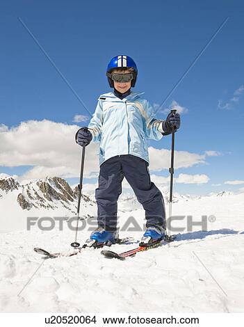 Boy skiing in snow, mountain backdrop View Large Photo Image Picture - Boy skiing in snow, mountain backdrop. Fotosearch
