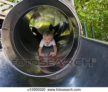 Boy sliding down a tunnel View Large Photo Image Stock Image - Boy sliding down a tunnel. Fotosearch