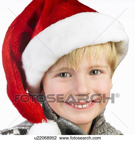 Boy wearing a christmas hat View Large Photo Image Stock Image - Boy wearing a christmas hat. Fotosearch