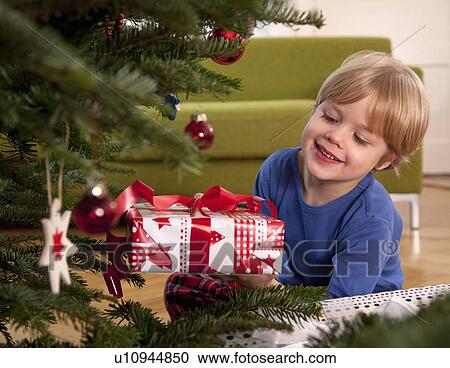 boy with christmas present View Large Photo Image Stock Image - boy with christmas present. Fotosearch