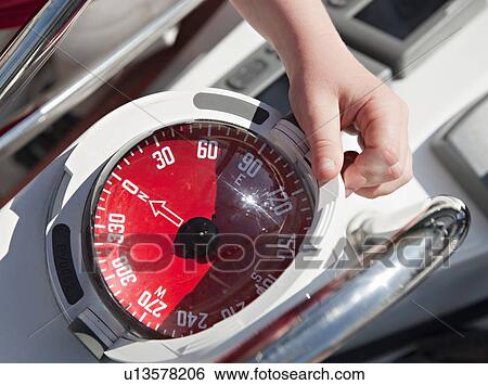 Stock Photograph - Boy with compass on yacht. Fotosearch