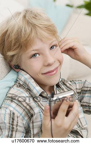 Stock Image - Boy with MP3 player smiling. Fotosearch